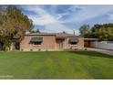 Charming brick home with a spacious lawn and carport at 2112 W Mulberry Dr, Phoenix, AZ 85015