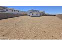 View of the home's back exterior showing the large, undeveloped backyard space at 2316 W Moody Trl, Phoenix, AZ 85041