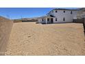 Spacious undeveloped backyard enclosed by a brick fence and mountain views at 2316 W Moody Trl, Phoenix, AZ 85041