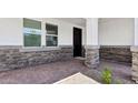 The front entrance has brick pavers and columns wrapped in stone at 2316 W Moody Trl, Phoenix, AZ 85041
