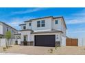 The exterior of the home features desert landscaping, a two-car garage, and neutral colors at 2316 W Moody Trl, Phoenix, AZ 85041