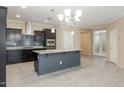 Modern kitchen with dark cabinets, granite island, and tile backsplash at 2702 E Saddlebrook Rd, Gilbert, AZ 85298