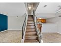 Modern staircase with wood-look laminate treads and metal railing at 3511 E Baseline Rd # 1147, Phoenix, AZ 85042