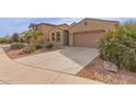 Tan house with a two-car garage and a curved driveway at 40861 W Little Dr, Maricopa, AZ 85138