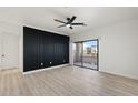 Bright bedroom with wood-look floors and access to a private balcony at 5345 E Van Buren St # 226, Phoenix, AZ 85008