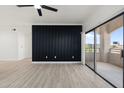 Living room with modern wall paneling and sliding door to balcony at 5345 E Van Buren St # 226, Phoenix, AZ 85008