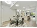 Modern glass dining table with four chairs in open kitchen at 7161 E Rancho Vista Dr # 3002, Scottsdale, AZ 85251