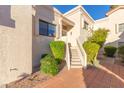 Condo entrance with stairs and lush green landscaping at 7800 E Lincoln Dr # 2004, Scottsdale, AZ 85250