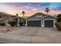 Two-story house with gray exterior, two-car garage, and desert landscaping at 810 S Lagoon Dr, Gilbert, AZ 85233