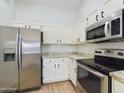 Bright kitchen with stainless steel appliances and granite countertops at 8623 W Athens St, Peoria, AZ 85382