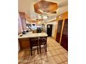 Cozy kitchen features wood cabinets and breakfast bar at 1006 E Pasadena Ave, Phoenix, AZ 85014