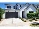 Two-story home with modern facade, landscaped yard, and two-car garage at 10150 E Thistle Ave, Mesa, AZ 85212