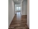 Bright hallway with wood-look floors leading to living spaces at 10150 E Thistle Ave, Mesa, AZ 85212