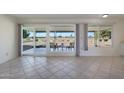 Bright dining area with large windows and golf course view at 10629 W Willow Creek Cir, Sun City, AZ 85373