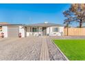 Modern home with gray driveway and landscaped lawn at 10902 W Flanagan St, Avondale, AZ 85323