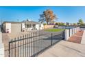 Home with a gated entry and artificial turf in the backyard at 10902 W Flanagan St, Avondale, AZ 85323