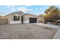 Charming one-story house with gray garage door and gravel driveway at 11225 E Marigold Ln, Florence, AZ 85132