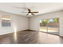 Bright and airy living room with sliding glass doors and wood-look floors at 11225 E Marigold Ln, Florence, AZ 85132