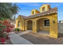 Attractive yellow two-story house with a welcoming front porch at 1161 S Storment Ln, Gilbert, AZ 85296