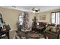 Spacious living room featuring a cozy leather couch and large TV at 1161 S Storment Ln, Gilbert, AZ 85296