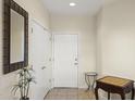 Bright entryway with chess table, mirror and coat closet at 15665 W Azalea Ln, Surprise, AZ 85374