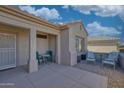 Covered patio with seating area, perfect for relaxing outdoors at 15665 W Azalea Ln, Surprise, AZ 85374