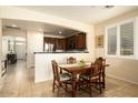 Charming dining room with a wood table and view into the kitchen at 17680 W Lilac St, Goodyear, AZ 85338