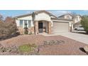 One-story home with a two-car garage and a neatly landscaped yard at 17680 W Lilac St, Goodyear, AZ 85338