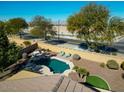 Inviting backyard oasis with a sparkling pool and ample seating at 17680 W Lilac St, Goodyear, AZ 85338