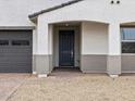 The house has an entryway with a dark-colored front door and an attractive tiled walkway at 17697 W Southgate Ave, Goodyear, AZ 85338