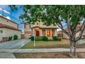 Two-story house with a tree in front and a manicured lawn at 1806 E Ellis St, Phoenix, AZ 85042