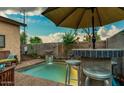 Inviting backyard pool area with a bar and patio furniture at 1806 E Ellis St, Phoenix, AZ 85042