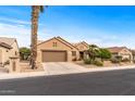 House exterior featuring a brown garage door and drought-tolerant landscaping at 18137 N Estrella Vista Dr, Surprise, AZ 85374