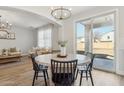 Charming dining area with a round table, modern chairs, and sliding glass doors to the patio at 18260 W Bridger St, Surprise, AZ 85388