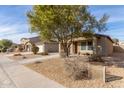 House exterior view showcasing landscaping and street at 194 E Watson Pl, Casa Grande, AZ 85122