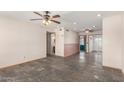 A spacious living room boasts slate floors and multiple ceiling fans for comfort at 1940 S Coconino Dr, Apache Junction, AZ 85120