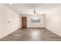 A bright living room features a window, a ceiling fan, and slate flooring at 1940 S Coconino Dr, Apache Junction, AZ 85120