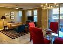 Bright dining area with a glass table and red chairs, leading to a patio at 20100 N 78Th Pl # 1092, Scottsdale, AZ 85255