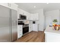 Bright kitchen featuring stainless steel appliances and white cabinetry at 20235 W Highland Ave, Litchfield Park, AZ 85340