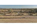 Picture of the empty lot for future home construction with desert landscape and mountain views at 20235 W Highland Ave, Litchfield Park, AZ 85340