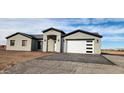 New single-story home with gray exterior, white garage door, and paved driveway at 31540 W Maricopa St, Buckeye, AZ 85326