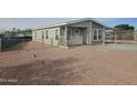 Front view of a manufactured home with gravel landscaping at 318 S Ellsworth Rd, Mesa, AZ 85208