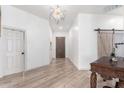 Bright entryway with hardwood floors, barn door, and modern chandelier at 3390 S Yaqui Ln, Gold Canyon, AZ 85118