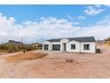 New construction home with two-car garage and mountain backdrop at 3390 S Yaqui Ln, Gold Canyon, AZ 85118