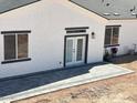 Newly built patio with gray pavers, set off the back of this stucco home with black trim and white French doors at 3390 S Yaqui Ln, Gold Canyon, AZ 85118