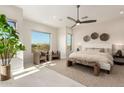 Serene main bedroom with a large window view, neutral decor, and a cozy seating area at 37178 N Winding Wash Trl, Carefree, AZ 85377