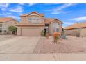 Two-story house with a tan exterior, landscaped yard, and two-car garage at 4028 N Ranier --, Mesa, AZ 85215