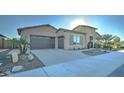 Attractive exterior showcasing a well-manicured front yard, a stone-accented entrance, and a spacious driveway at 4053 E Zion Way, Chandler, AZ 85249