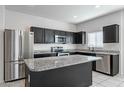 Spacious kitchen with granite countertops and stainless steel appliances at 41838 W Chatham Pl, Maricopa, AZ 85138