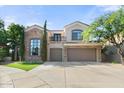 Beautiful two-story home with three-car garage and manicured lawn at 5019 E Lucia Dr, Cave Creek, AZ 85331